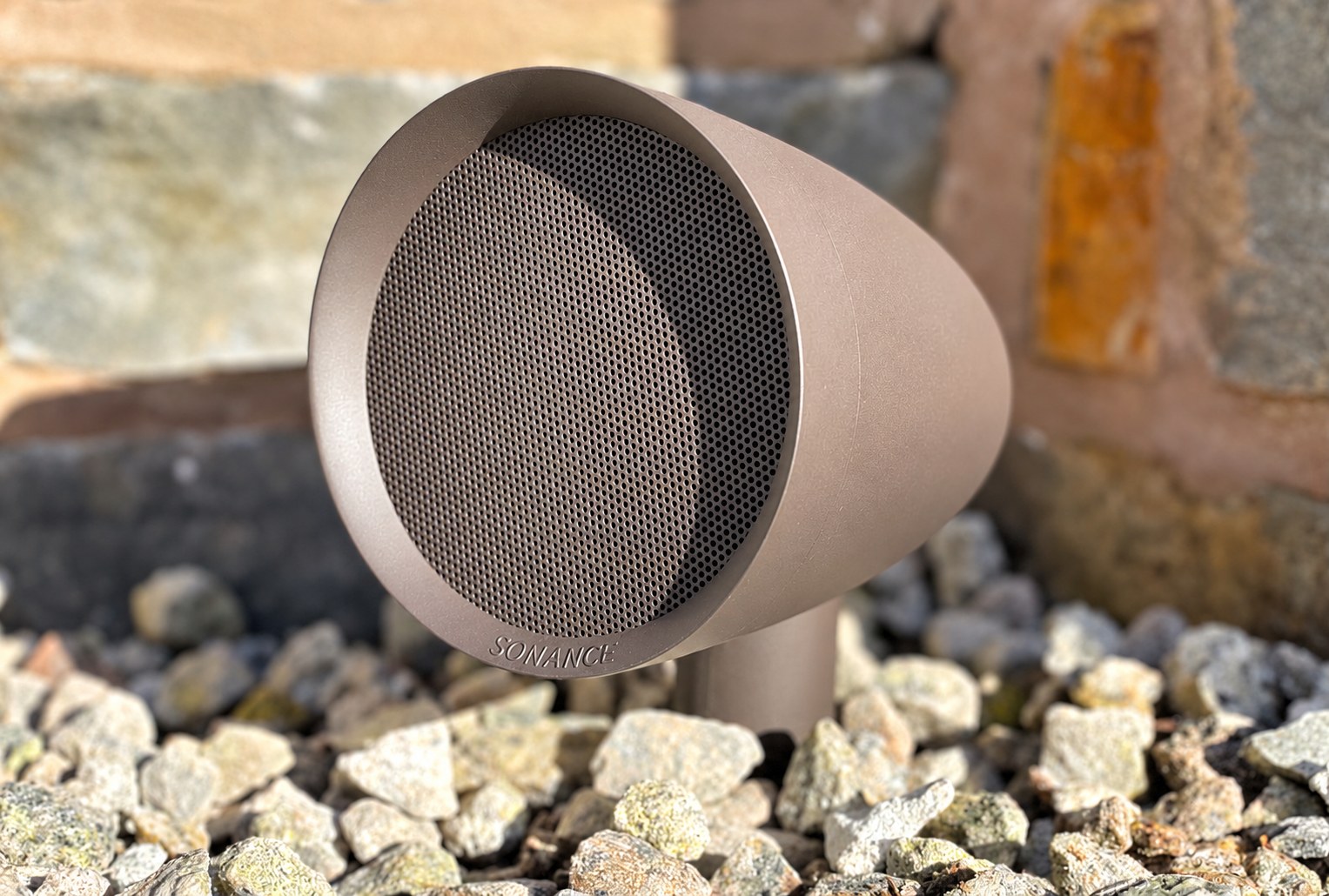 Discreet outdoor loudspeaker in a garden