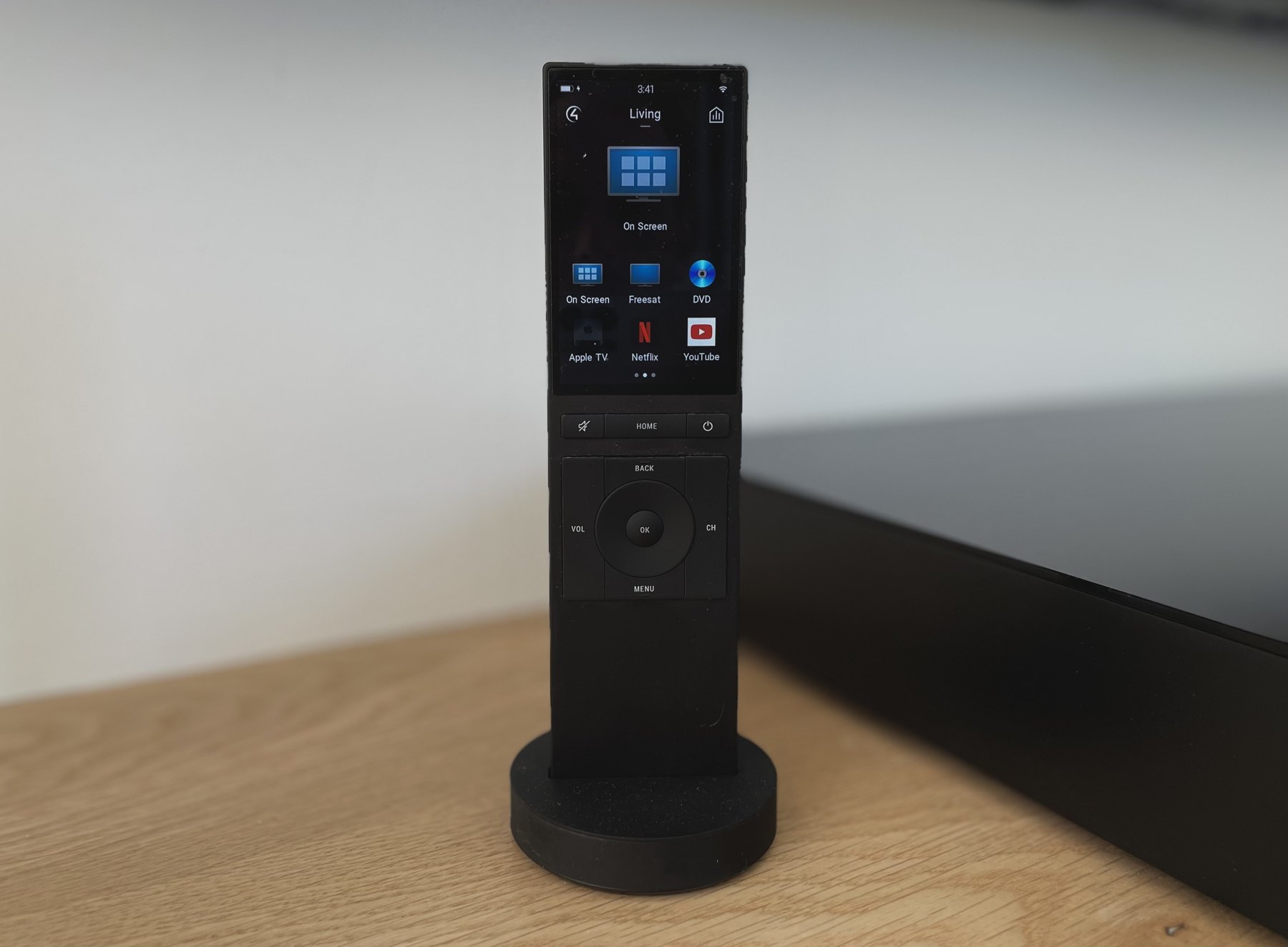 Touchscreen remote control on its charging stand
