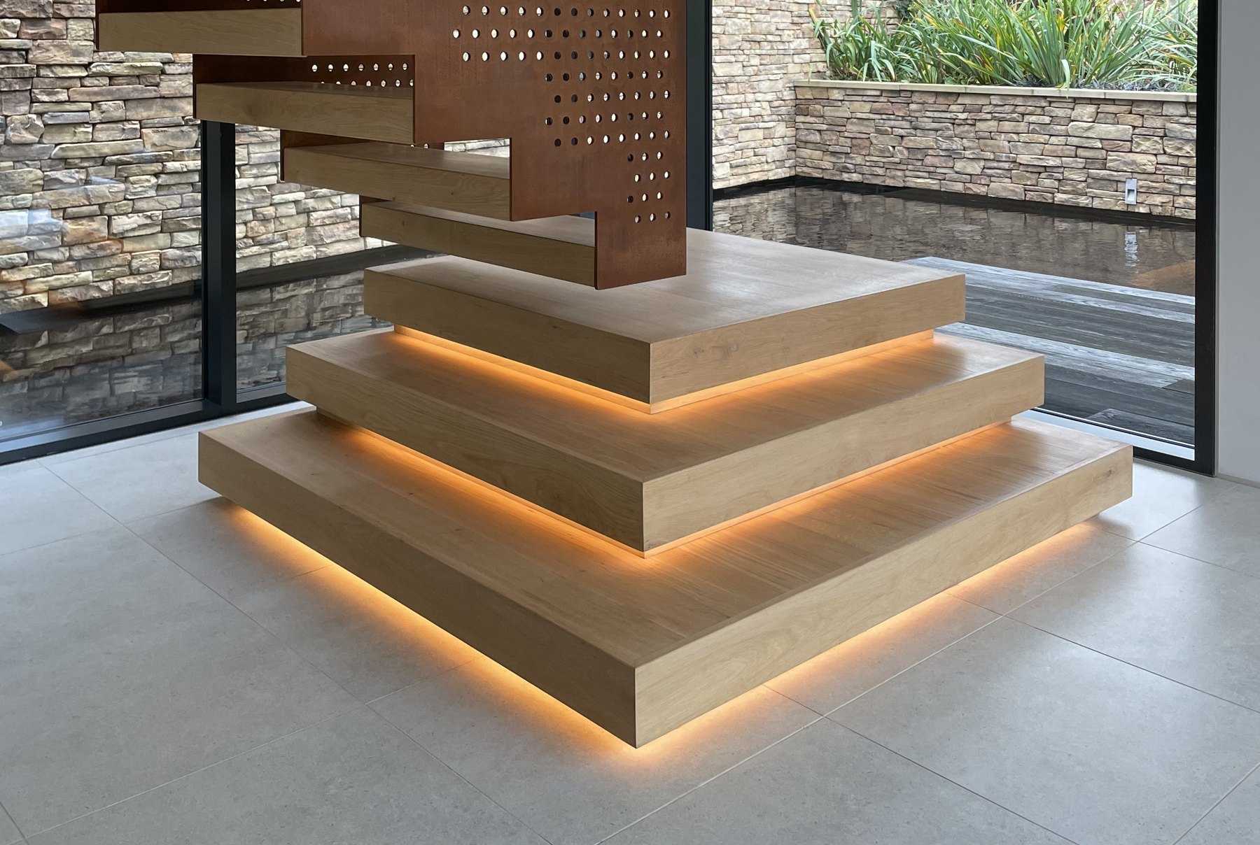 Warm integrated lighting beneath timber stair treads