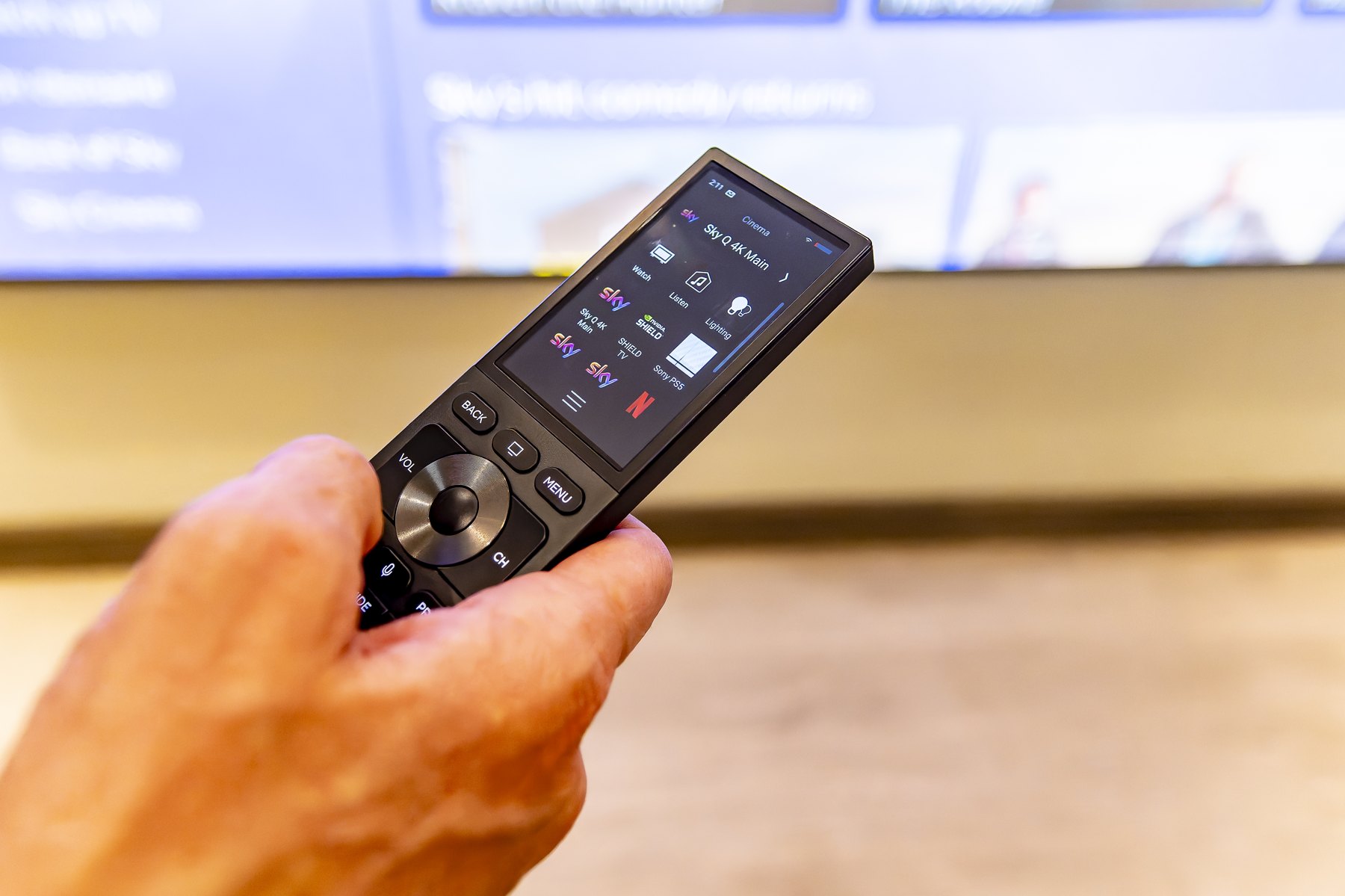 Handheld touchscreen remote controlling the entertainment system