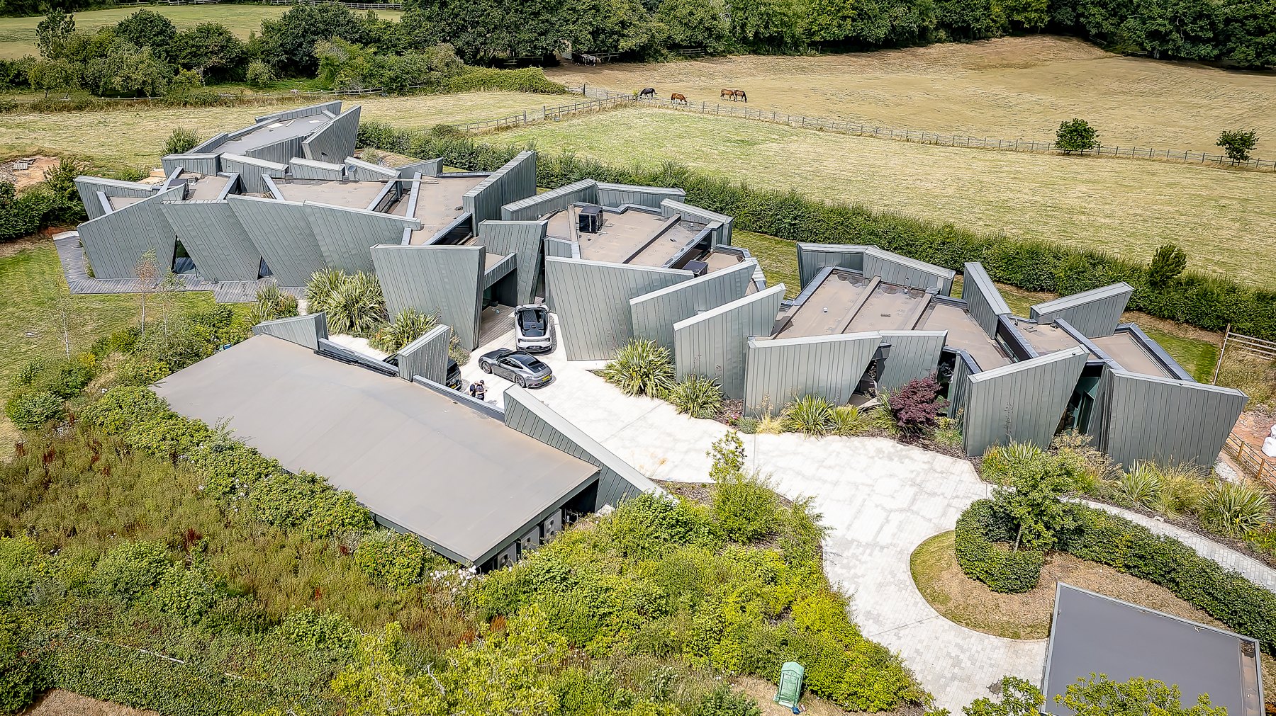 Aerial view of the contemporary home and landscaped grounds